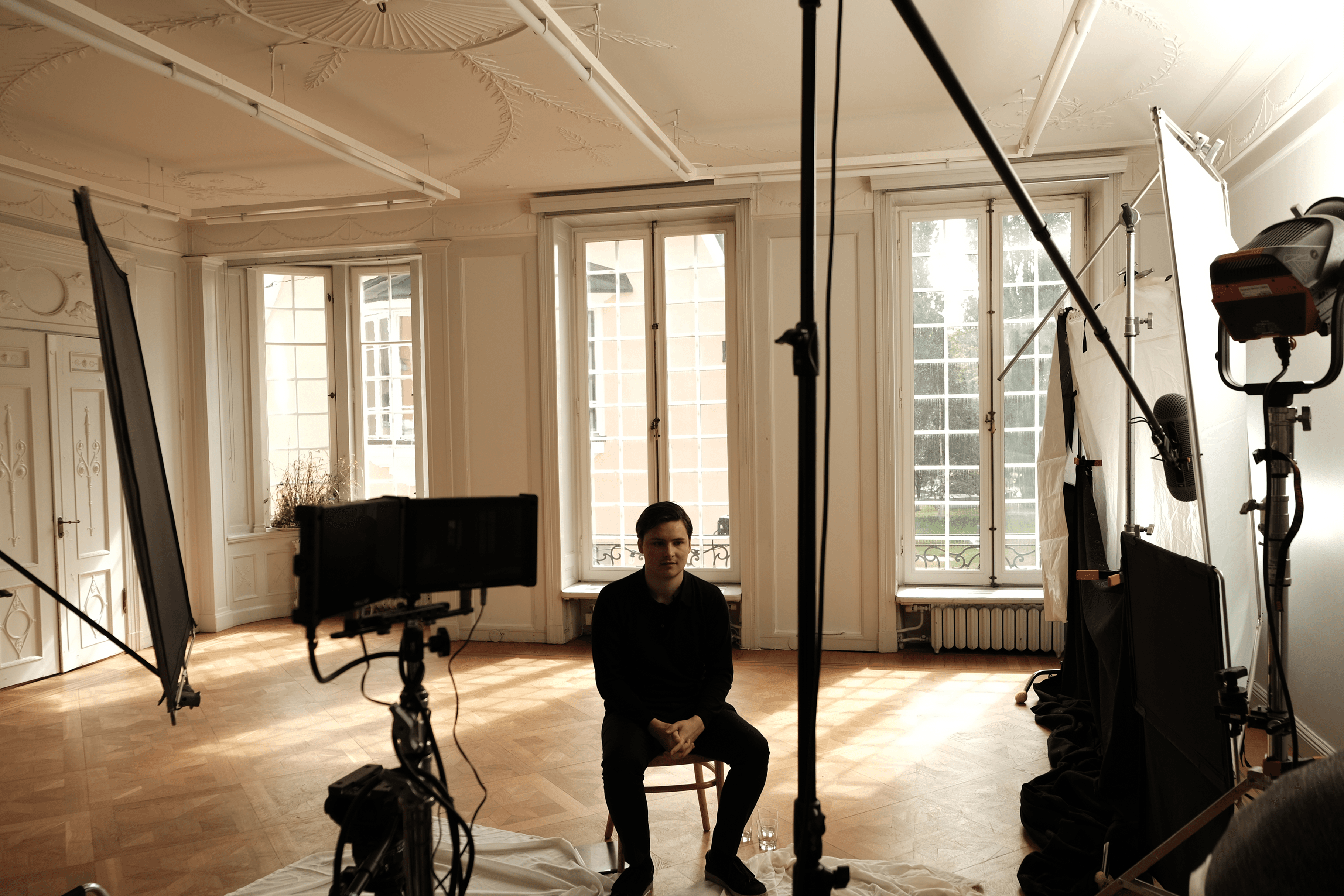 A Scape teammate seated in a studio setup.